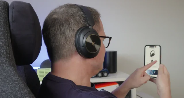 person using the OneOdio Focus A6 with their phone