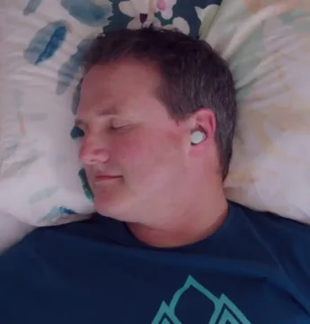person asleep on a pillow wearing the soundcore Sleep A30 earbuds